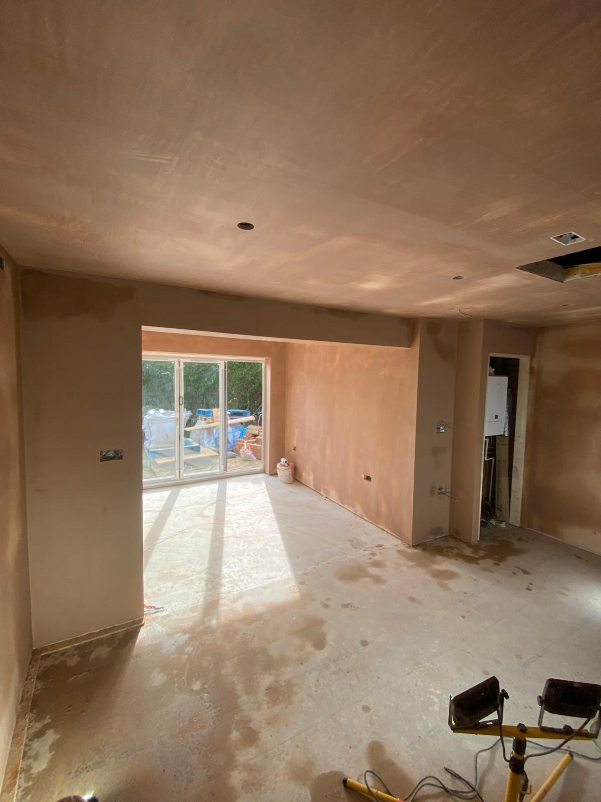 Freshly plastered open-plan room with skimmed walls and ceiling